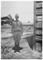 Lieutenant O. P. Leithauser with the officers barracks in the rear. The low one.