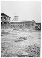 The watch tower. A guard is on duty night and day. From here you can see all over the camp. The building this way is the temporary hospital.